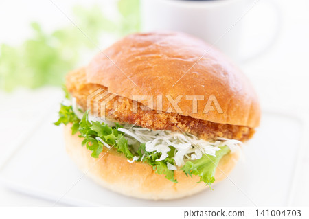 A delicious katsu burger and coffee for breakfast. A delicious katsu burger and coffee for breakfast. 141004703