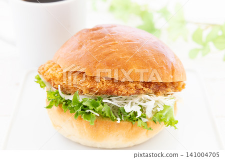 A delicious katsu burger and coffee for breakfast. A delicious katsu burger and coffee for breakfast. 141004705