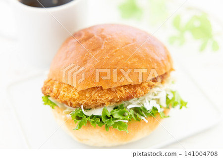 A delicious katsu burger and coffee for breakfast. A delicious katsu burger and coffee for breakfast. 141004708
