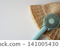 Using a portable fan and a straw hat to cope with the heat. 141005430