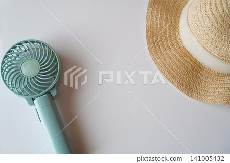 A handy fan and a straw hat for protection against the summer heat (image) A handy fan and a straw hat for protection against the summer heat (image) 141005432