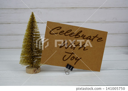 Celebrate with Joy text written on paper card for Christmas holidays celebration Celebrate with Joy text written on paper card for Christmas holidays celebration 141005750
