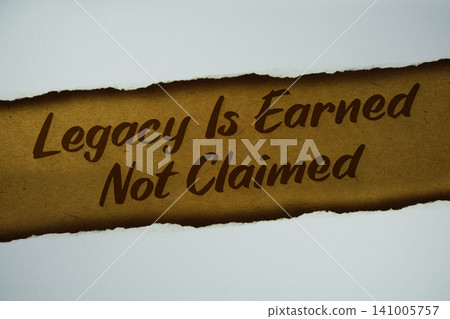 Legacy Is Earned Not Claimed text written on paper craft background Legacy Is Earned Not Claimed text written on paper craft background 141005757