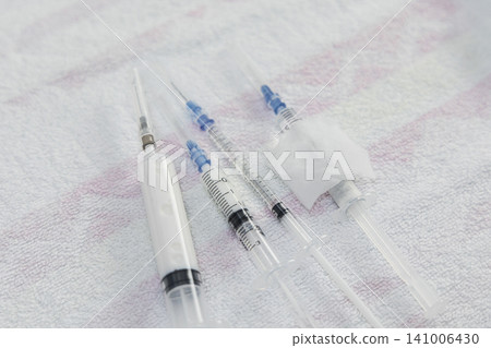 Medical syringes and anesthetic needles: A close-up of preparations for local anesthesia procedures. Medical syringes and anesthetic needles: A close-up of preparations for local anesthesia procedures. 141006430