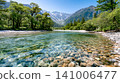 A landscape of a valley with clear water flowing through it. 141006477