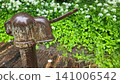 Antique Cast Iron Water Pump Mechanism with Garden Background 141006542