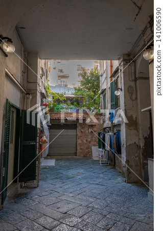 Naples, italy. December 27, 2024. Urban residential courtyard in naples, italy, showing typical daily life with laundry hanging and traditional building architecture 141006590
