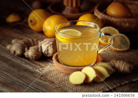 Ginger tea with fresh lemon on an old wooden table. Ginger tea with fresh lemon on an old wooden table. 141006656