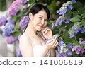 A smiling woman with hydrangeas 141006819