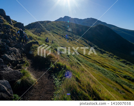 Green ridgeline stretching towards the summer blue sky Green ridgeline stretching towards the summer blue sky 141007038