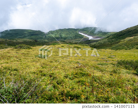 A refreshing breeze blows along the green mountain ridge trail. A refreshing breeze blows along the green mountain ridge trail. 141007115