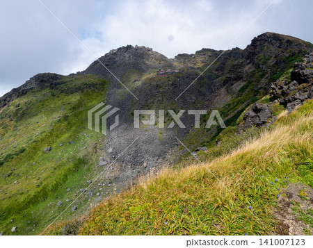 A magnificent panorama unfolds at the end of the light-filled mountain trail. A magnificent panorama unfolds at the end of the light-filled mountain trail. 141007123