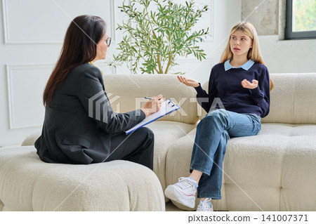 Teenage student talking to school psychologist Teenage student talking to school psychologist 141007371