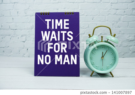 Time Waits For No Man text with Mint Green Alarm Clock on wooden Background Time Waits For No Man text with Mint Green Alarm Clock on wooden Background 141007897