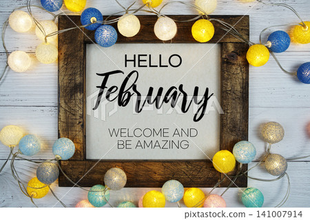 Hello February text with LED cotton ball decoration on wooden background Hello February text with LED cotton ball decoration on wooden background 141007914