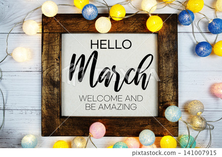 Hello March text with LED cotton ball decoration on wooden background Hello March text with LED cotton ball decoration on wooden background 141007915