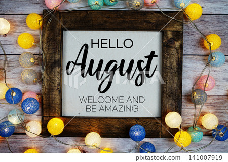 Hello August text with LED cotton ball decoration on wooden background Hello August text with LED cotton ball decoration on wooden background 141007919