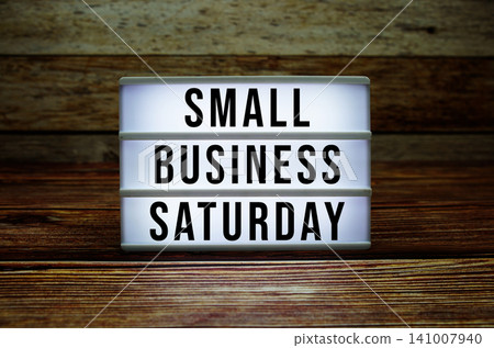 Lightbox with text "Small Business Saturday" on wooden background Lightbox with text "Small Business Saturday" on wooden background 141007940