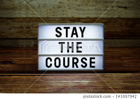 Lightbox with text "Stay The Course" on wooden background Lightbox with text "Stay The Course" on wooden background 141007942