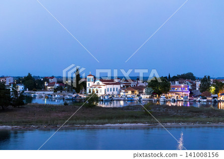Keramoti, Greece, St. Nicholas Orthodox Church and fishing boats in the harbor Keramoti, Greece, St. Nicholas Orthodox Church and fishing boats in the harbor 141008156