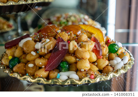 Naples, italy. December 27, 2024. Struffoli, small deep fried dough balls, glazed with honey and decorated with colorful sprinkles and candied fruit. Italian christmas pastry from naples 141008351