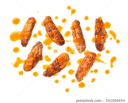 crunchy buffalo chicken wings with Cayenne pepper sauce isolated on white background, top view. Hot and spicy red Buffalo sauce for chicken wings crunchy buffalo chicken wings with Cayenne pepper sauce isolated on white background, top view. Hot and spicy red Buffalo sauce for chicken wings 141008454