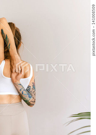 Woman Shoulder and Back Stretching Back View Woman Shoulder and Back Stretching Back View 141008509