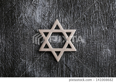 Jewish star of david on old wooden wall Jewish star of david on old wooden wall 141008682