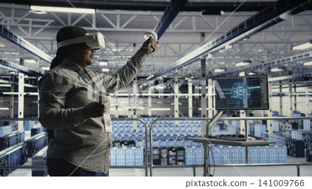 Data center engineer uses a green screen tablet in a server room for AI workflow and screen replacement. Data center engineer uses a green screen tablet in a server room for AI workflow and screen replacement. 141009766