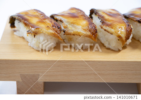 Eel grasping sushi 141010671
