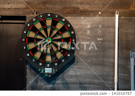 Dartboard next to the blackboard 141010787