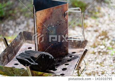 Charcoal and tools for a campfire Charcoal and tools for a campfire 141010795