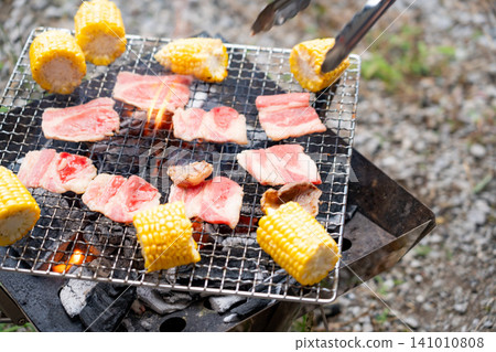 Charcoal-grilled meat and corn Charcoal-grilled meat and corn 141010808