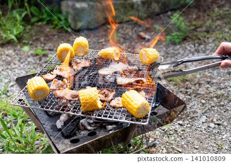 Charcoal barbecue with flames rising Charcoal barbecue with flames rising 141010809