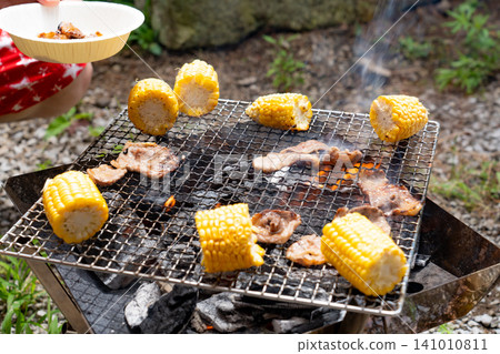 Charcoal-grilled meat and corn Charcoal-grilled meat and corn 141010811