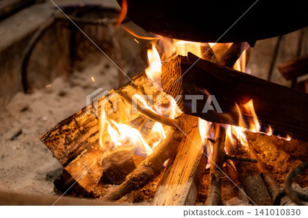 The fire in the hearth with burning wood The fire in the hearth with burning wood 141010830