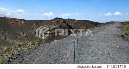 A walk along the edge of the crater of the San Antonio volcano on the Canary Island of La Palma along the tourist trail. High quality photo A walk along the edge of the crater of the San Antonio volcano on the Canary Island of La Palma along the tourist trail. High quality photo 141011718