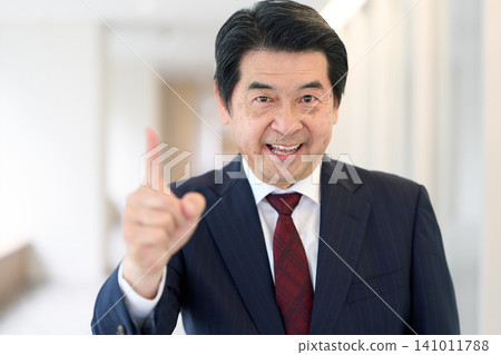 A senior Asian businessman pointing his finger. 141011788