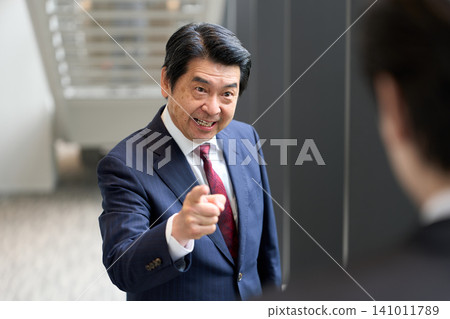 Senior businessman points finger angrily 141011789