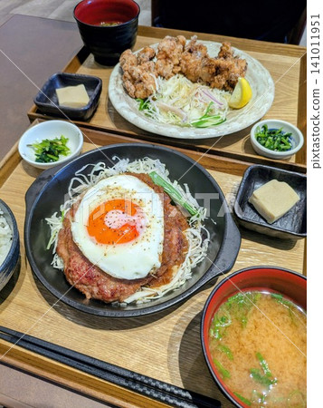 Hamburg steak with a fried egg on top and fried chicken set meal Hamburg steak with a fried egg on top and fried chicken set meal 141011951