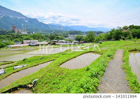 Mount Bukō and Terasaka Rice Terraces: A lush green landscape during rice planting season. Mount Bukō and Terasaka Rice Terraces: A lush green landscape during rice planting season. 141011994