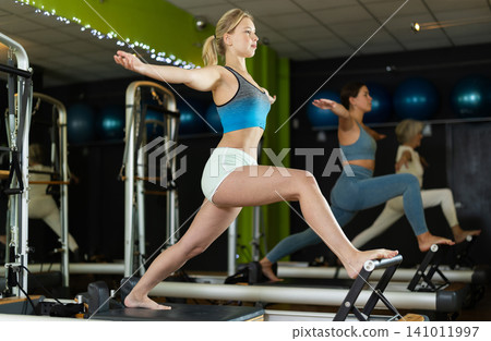 Woman doing leg exercises Woman doing leg exercises 141011997