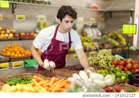 Man worker seller in grocery vegetable shop assort fruit daicon radish 141012127
