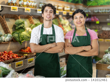 Male and female sellers sellers in vegetable shop Male and female sellers sellers in vegetable shop 141012461