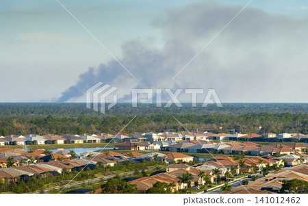 Suburban neighborhood in Florida suffering from bad air quality polluted with prescribed forest fire smoke Suburban neighborhood in Florida suffering from bad air quality polluted with prescribed forest fire smoke 141012462