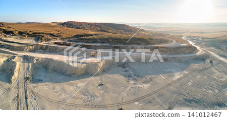 Aerial view of open pit mine of sandstone materials for construction industry with excavators and dump trucks. Heavy equipment in mining and production of useful minerals concept Aerial view of open pit mine of sandstone materials for construction industry with excavators and dump trucks. Heavy equipment in mining and production of useful minerals concept 141012467