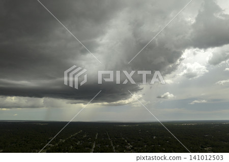 Tropical thunderstorm precipitation falling down on Florida town. Rain shower in summer Tropical thunderstorm precipitation falling down on Florida town. Rain shower in summer 141012503
