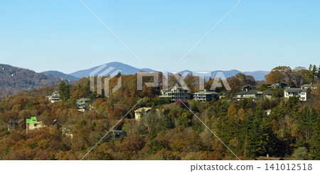 Aerial view of expensive american homes on hilltop in North Carolina mountains residential area. New family houses as example of real estate development in USA suburbs Aerial view of expensive american homes on hilltop in North Carolina mountains residential area. New family houses as example of real estate development in USA suburbs 141012518