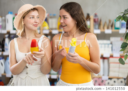 Women choose a repellent in the store 141012550