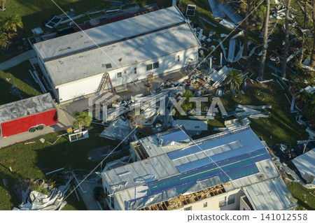 Severely damaged houses after hurricane Ian in Florida mobile home residential area. Consequences of natural disaster Severely damaged houses after hurricane Ian in Florida mobile home residential area. Consequences of natural disaster 141012558